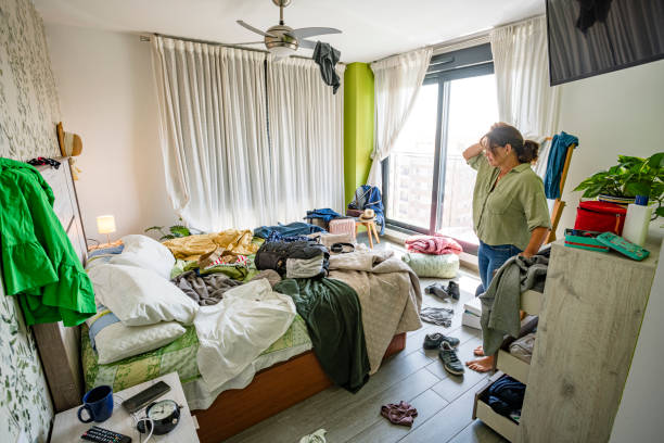 istock Upset woman head in hands contempling her messy bedroom 2164646983