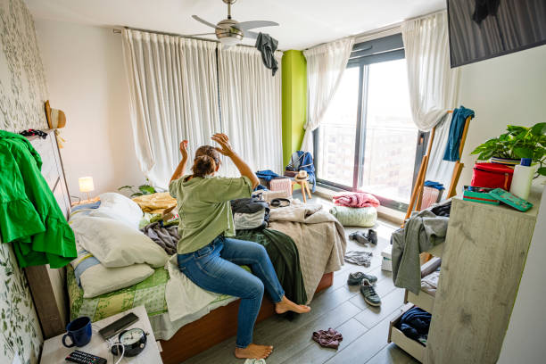 istock Upset housewife contempling her messy bedroom 2164646994