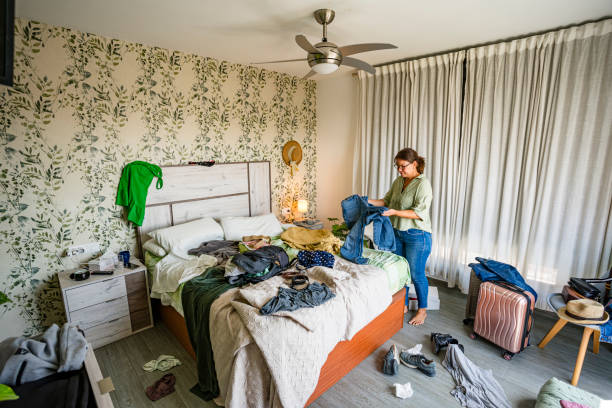 istock Woman is arranging her messy bedroom 2164647021