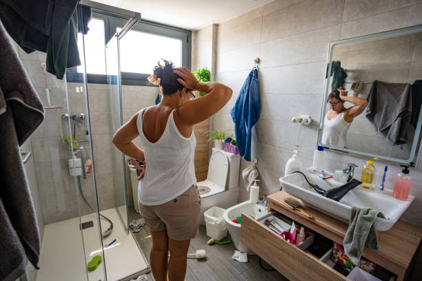 istock Woman head in hands contempling her messy bathroom 2164647048