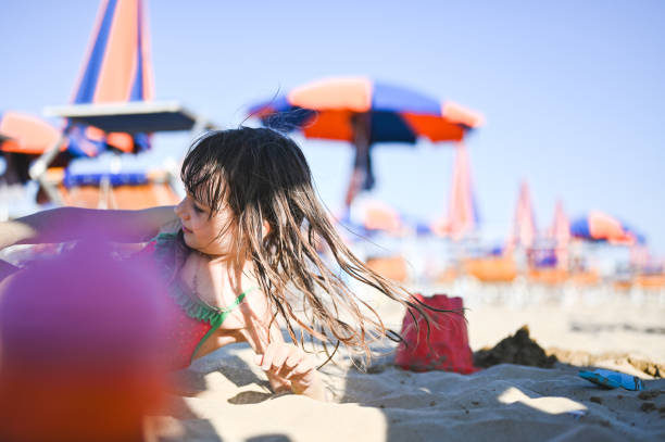 Girl playing with sand.