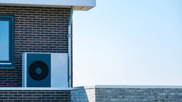 istock Air Source Heat Pump Installed on Modern Building Roof on a Sunny Day 2164647580