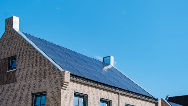 istock Modern Solar Panels Adorning a Contemporary Home Under a Bright Blue Sky 2164647581