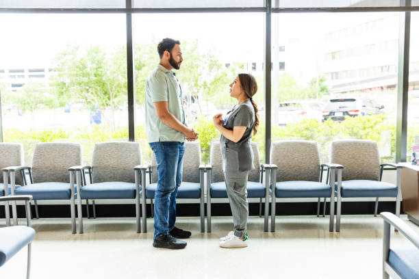 istock Profile view young man listening to female nurse practitioner 2164649260
