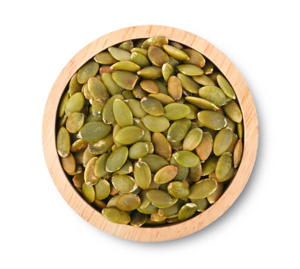 istock Pumpkin Seed in wood bowl on white background top view 2164652787