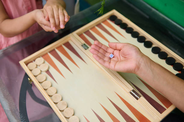 istock Family quality time playing backgammon board game at home 2164653183