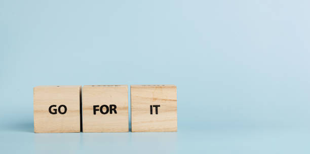 istock Wooden cubes with inscriptions Go For It on a blue background 2164655596