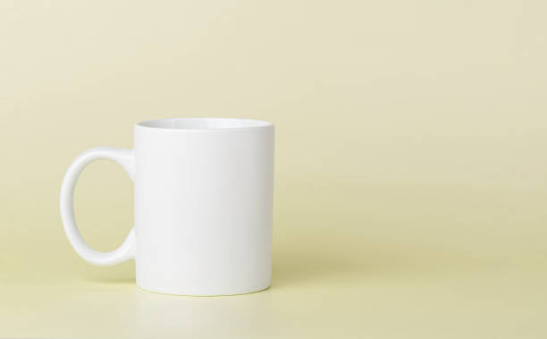 istock white cup for tea or coffee on a yellow background 2164655603