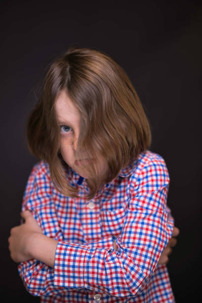Blue-eyed boy with freckles looking afraid.
