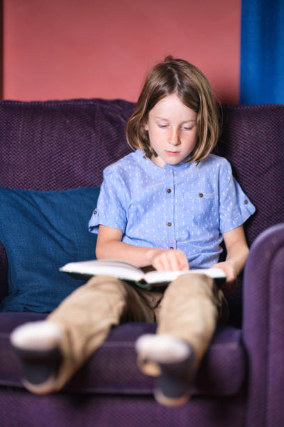 istock Seven-year-old boy reading in an armchair 2164657724