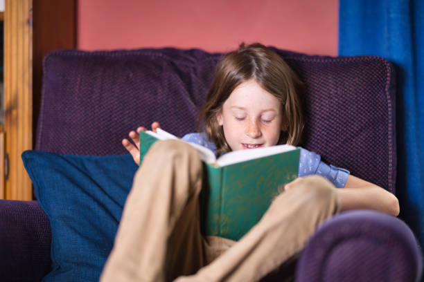 istock Seven-year-old boy reading in an armchair 2164657908