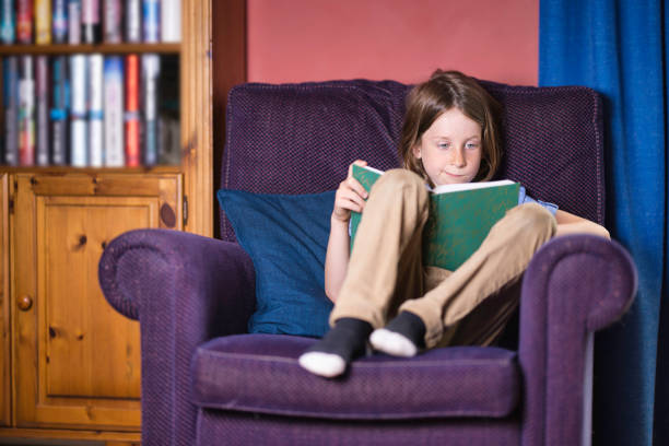istock Seven-year-old boy reading in an armchair 2164657930