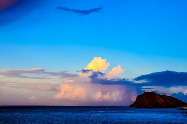 A beautiful blue sky with a large cloud in the middle. The sky is clear and the sun is shining brightly