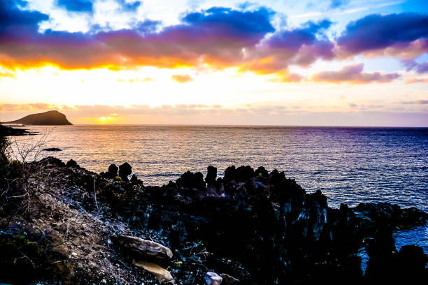istock A beautiful sunset over the ocean with a rocky shoreline 2164659035