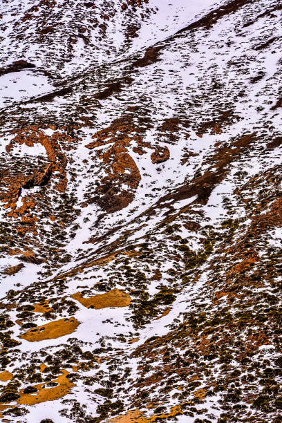 istock A close up of a rocky, snow covered mountain 2164659038