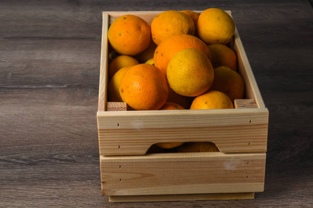 istock Oranges and old box. On a wooden background. 2164659160