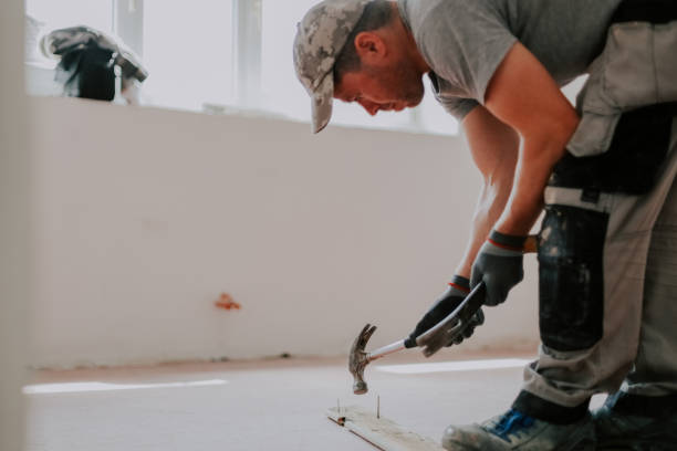 istock The hands of a man pull out nails with a crowbar. 2164660422