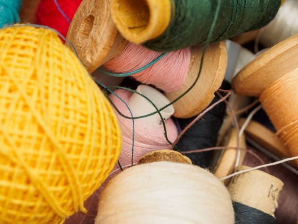 istock Multicolored Sewing Thread Spools: Vibrant hues are perfect for creating unique textiles and projects 2164661109