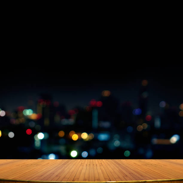istock Empty wooden surface with copy space over cityscape lights at night 2164661792
