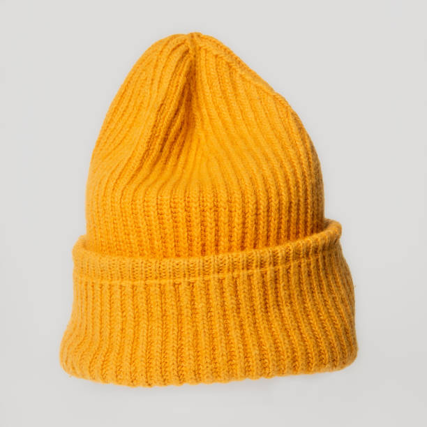 istock Bright orange knitted hat close-up. A warm and stylish accessory with an expressive texture, ideal for the cold 2164661879