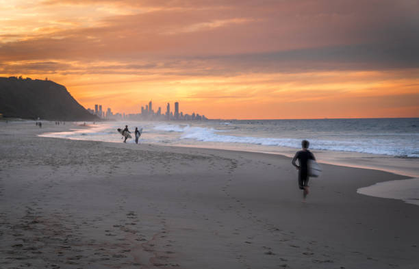 istock A surfer running on the beach in Goald Coast, Australia 2164662893