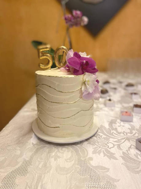 istock Birthday cake decorated with natural orchid. 2164664384