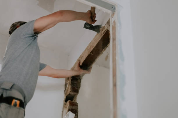 istock A young Caucasian male builder clears a doorway using a crowbar. 2164664890