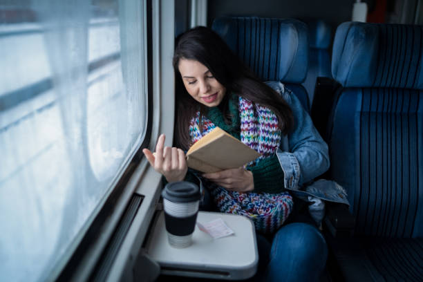 istock Woman reading book while traveling with the train 2164666637