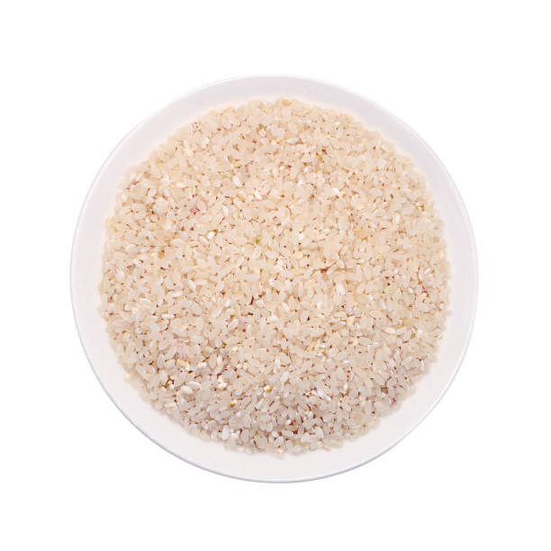 istock Rice grains in a plate on a white background. Isolated 2164670096