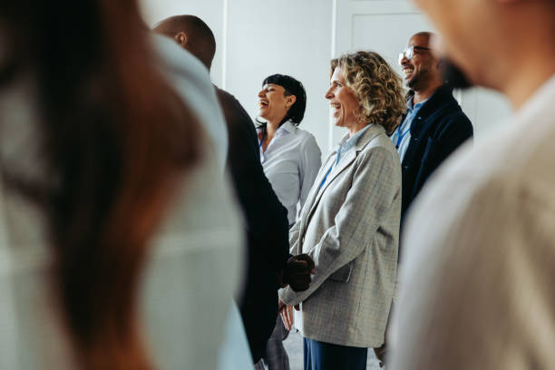 istock Business professionals laughing together during a conference event, creating a positive and engaging atmosphere 2164671177