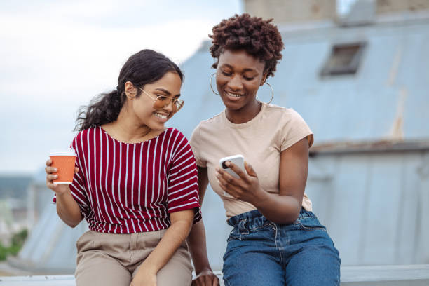 istock Two female friends cheerfully chatting and having coffee 2164671406