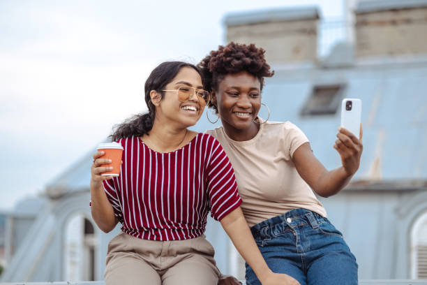 istock Diverse female friends taking selfie on the rooftop 2164671410