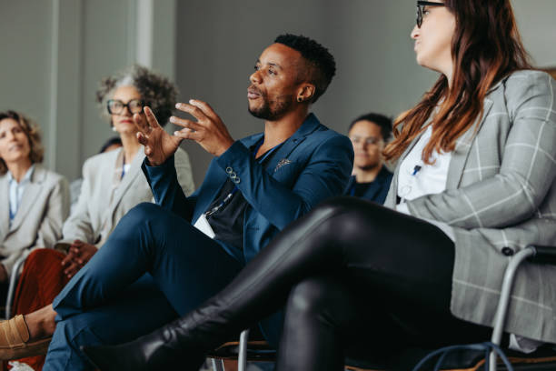 istock Black business man speaking at a workshop with colleagues in a conference setting 2164671938