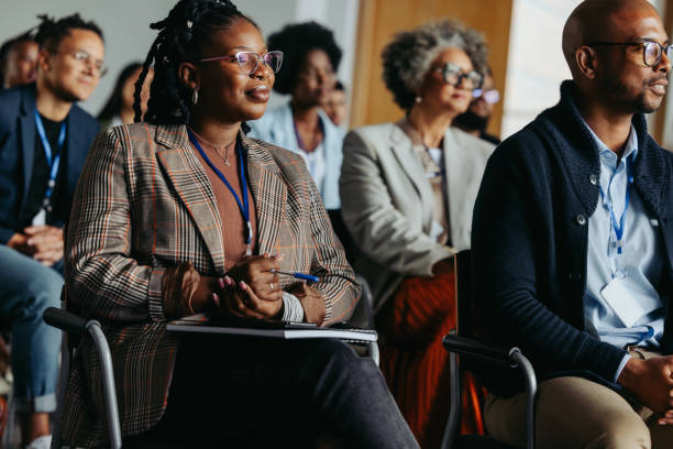 istock Diverse business audience attending a conference presentation, colleagues sitting and taking notes 2164672023