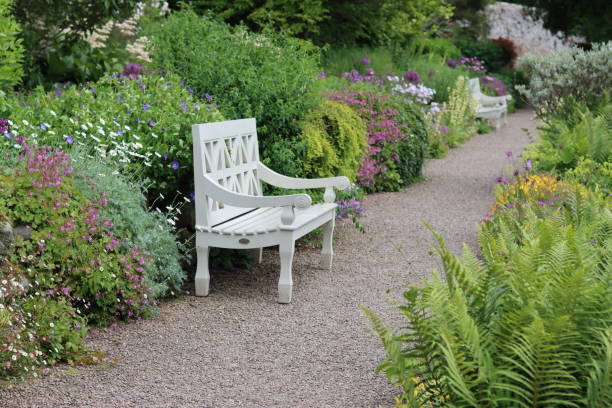 istock Garden seat surrounded by colourful flower beds 2164672192