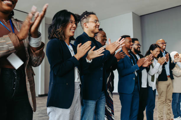 istock Diverse group of business employees applauding during a celebration event 2164672198