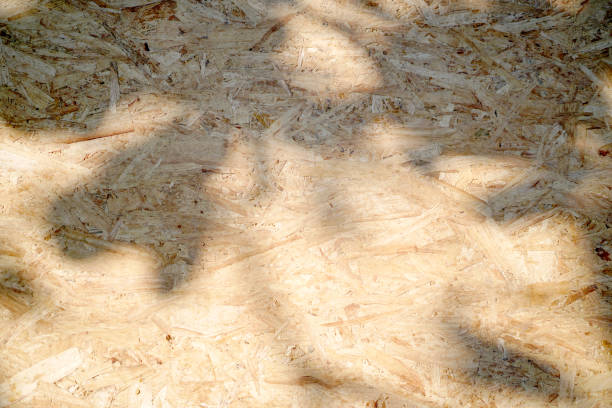 istock Old brown plywood recycled compressed wood chippings board texture with light and shadow for abstract background. Material design.board patterns, space for work, banner, wallpaper. Close up. 2164678574