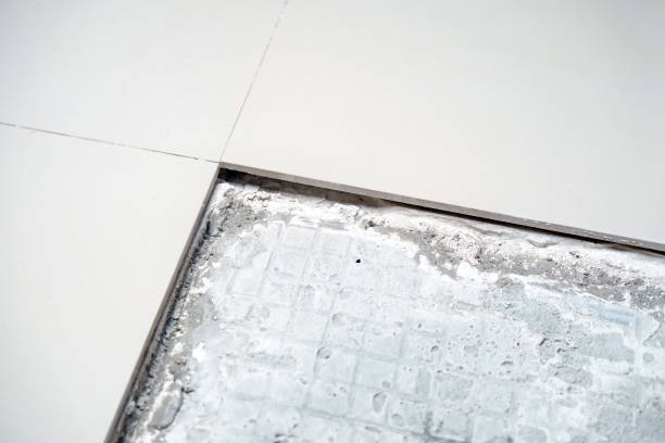 istock House or office building tiles floor problem. Brown ceramic tiles floor removed for renovation or repair, service and construction background concept. Close up. 2164678863