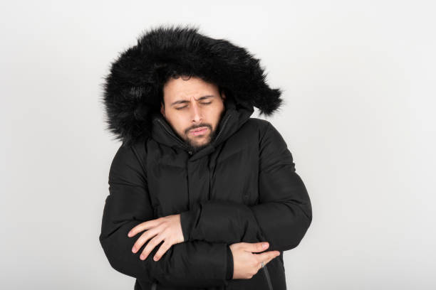 istock Man wearing black coat with very cold expression 2164685723
