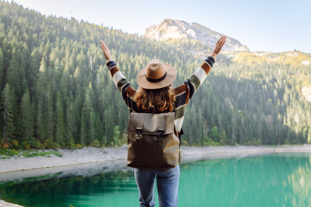 istock Active woman with backpack enjoying wild nature. 2164688407