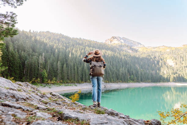 istock Active woman with backpack enjoying wild nature. 2164688417