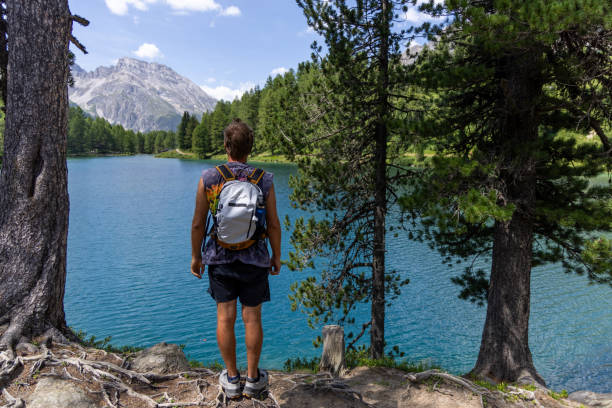 istock Man Admiring Mountain Lake View 2164689859