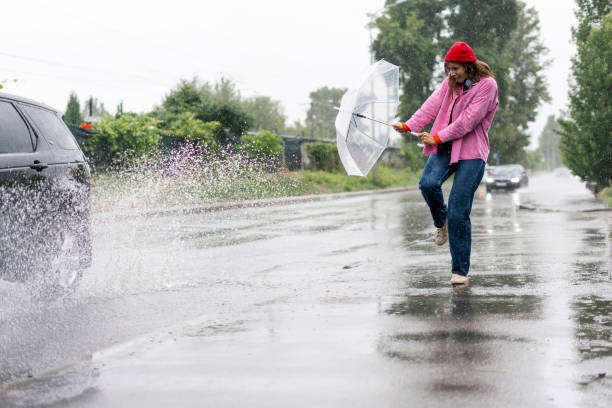 istock Scared woman hiding from spray with transparent umbrella 2164691279