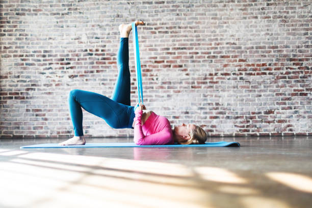 istock Yoga teacher practicing yoga with exercise ban, bridge position 2164698614