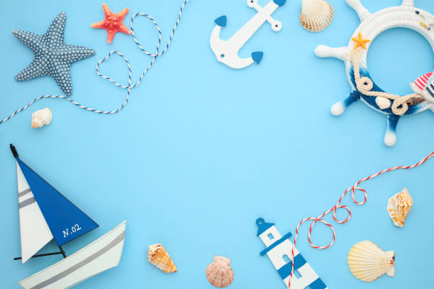 istock Nautical summer theme with starfish, anchor, seashells, lighthouse and sailboat on blue backdrop. Ideal for marine and vacation designs 2164703498