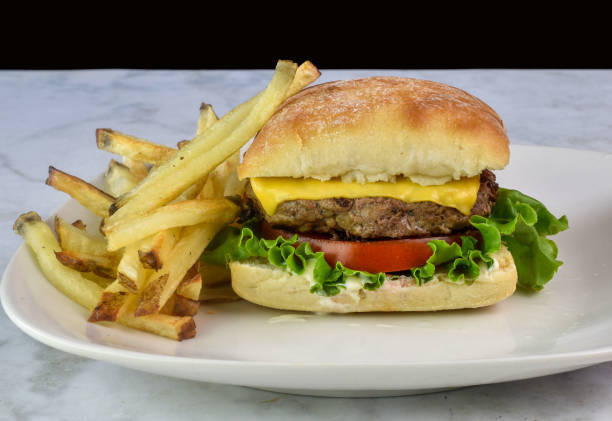 istock cheese burger  on a brioche bun served with fries 2164703950