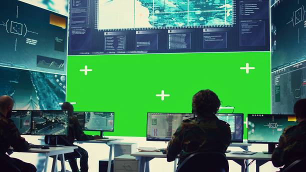 istock Team of IT military specialists working with a greenscreen on a big display 2164704247
