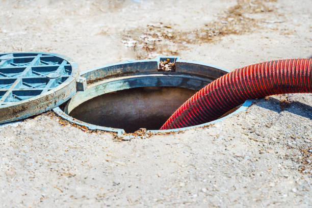 istock Pipe in the drainage pit. Pumping out sewage from a septic tank. Sewer cleaning service. 2164708377