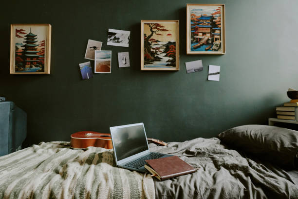 istock Single Bed with Laptop and Guitar on Top 2164708481