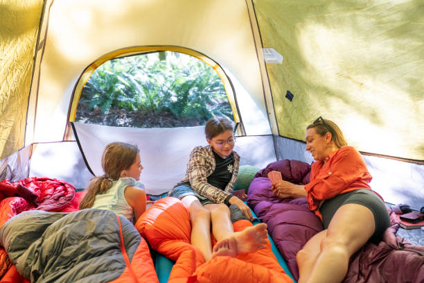 istock Mother and daughters relax in tent 2164712281